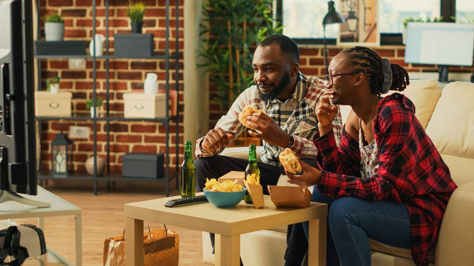 African american people eating burgers and fries